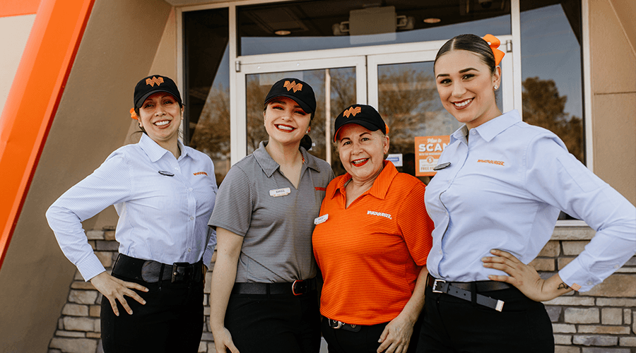 Multiple female employees in front of whataburger